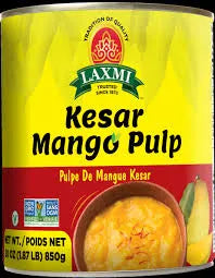 Can of Laxmi Kesar Mango Pulp with yellow label and mango image.