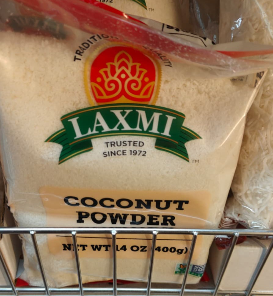 Bag of Laxmi Coconut Powder on a grocery store shelf with other products.