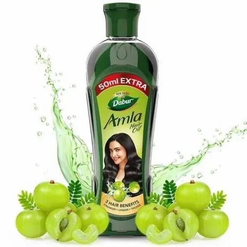 Dabur Amla hair oil bottle with amla fruits on a white background