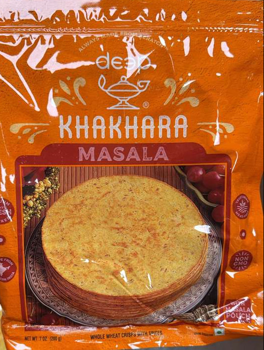 Packaged food item with 'Khakhara Masala' branding on a blurred background