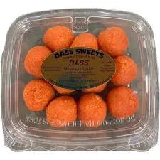 Packaged orange spherical treats with a label on a clear background